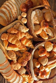 breads and pastries are arranged on a table