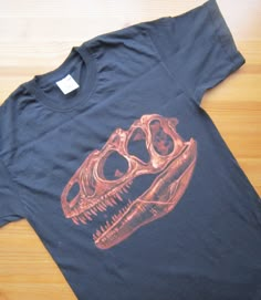 a t - shirt with an image of a dinosaur skull on it