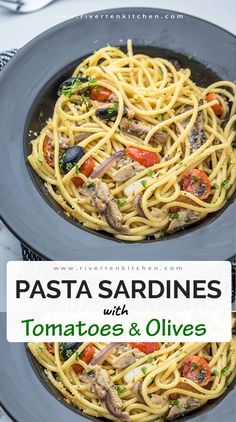 pasta with tomatoes and olives in a skillet on top of a white table