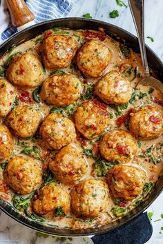 a skillet filled with meatballs covered in sauce