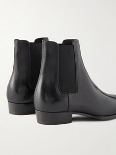 SAINT LAURENT revisits its signature 'Wyatt' boots in so many new colourways and fabrications each season, but this versatile black leather pair is perhaps the wisest investment. They've been impeccably made in Italy with elasticated side panels and are set on Cuban heels. They break at the perfect height to wear with the brand's skinny-fit jeans or tailored trousers. Designer Chelsea Boots With Leather Sole For Business, Designer Chelsea Boots With Reinforced Heel In Calf Leather, Luxury Chelsea Boots With Leather Lining, Black Goodyear Welted Chelsea Boots In Calf Leather, Designer Boots With Leather Sole For Business, Designer Chelsea Boots With Calf Leather, Black Calf Leather Chelsea Boots With Snip Toe, Black Snip Toe Chelsea Boots In Calf Leather, Designer Leather Lined Boots For Business