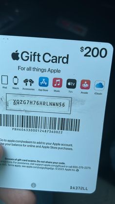 someone is holding up a $ 200 apple gift card in their left hand, with the bar code for all things apple