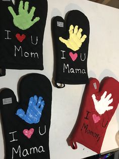 three oven mitts with handprints on them and i love you mama written on them