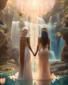 two beautiful women standing in front of a waterfall