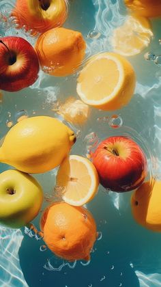 apples, oranges and lemons floating in water