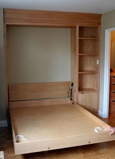 a bedroom with a bed, bookcase and dresser