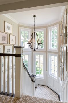 a chandelier hanging from the side of a staircase