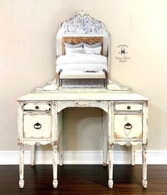 an antique white desk with a mirror on top