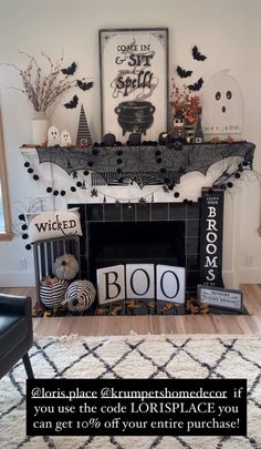 a living room decorated for halloween with black and white decorations on the fireplace mantel