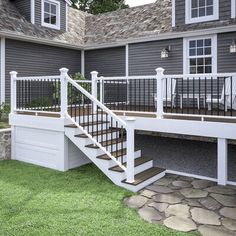 a house with a deck and stairs leading up to it