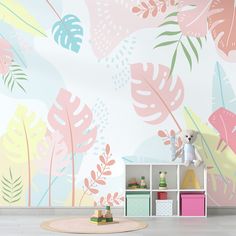 a child's room decorated in pastel colors with tropical leaves on the wall