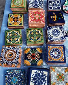 many colorful tiles are laid out on a table