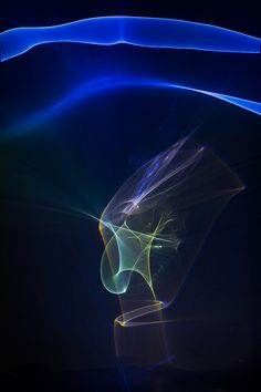 an abstract image of blue and yellow light coming from the back of a person's head