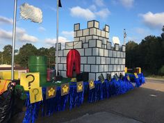 there is a fake castle made out of lego blocks and plastic streamers on the street