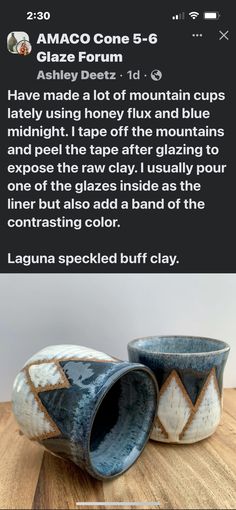 two blue and white vases sitting on top of a wooden table next to each other