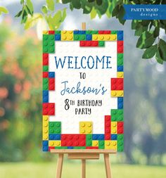 a welcome sign made out of legos on an easel for a birthday party