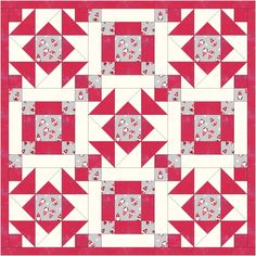 a red and white quilt with an arrow design on it's center piece, in the middle