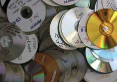 many cds are stacked up together on top of each other