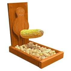 a corn on the cob in a wooden box filled with peanuts and corn kernels