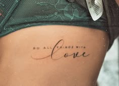 a woman's stomach with the words do all things with love written on it