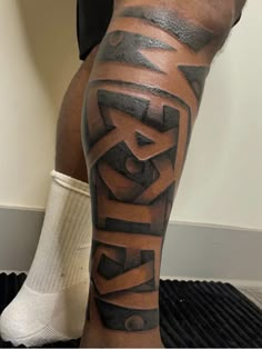 a man's leg with the word king written in black and grey ink on it