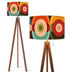 two lamps with different designs on them sitting next to each other in front of a white background