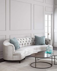 a living room filled with furniture and white walls