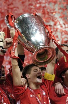 the liverpool united players celebrate with the trophy