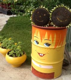 two yellow flower pots with sunflowers in them