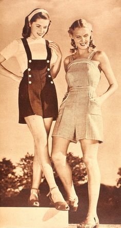 two young women standing next to each other in short shorts and overalls, posing for the camera