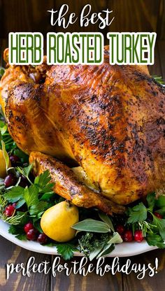 a roasted turkey on a platter with fresh herbs and lemons for the holiday