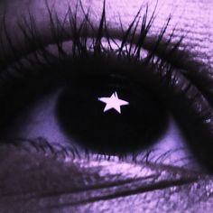 an image of a person's eye with a white star on the iris lens