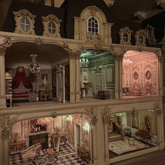 an elaborate doll house is shown with all the furniture in it's display case