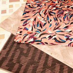 three different types of fabric laying on top of each other, one pink and the other black