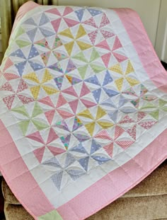 a colorful quilt on top of a chair