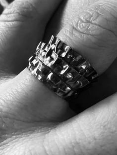 a close up of a person's hand with a ring on it