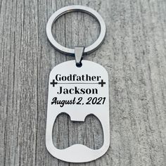 a bottle opener keychain with the words godfather, jackson august 22, 2021 printed on it