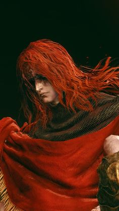 a man with long red hair is dressed in armor