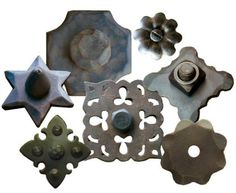 an assortment of various metal objects on a white background