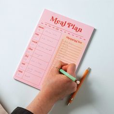 a person is writing on a meal plan