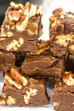 there are many pieces of chocolate with nuts on top