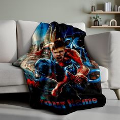 the amazing spider - man fleece blanket is shown on a couch