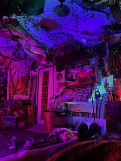 a bedroom with purple and blue lights on the ceiling