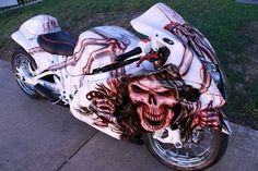 a white motorcycle with red and black designs on it