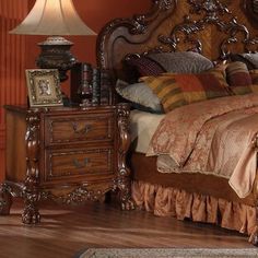 a bedroom with a bed, dresser and lamp on the side table in front of it