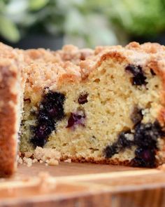 blueberry crumb cake cut in half on a cutting board