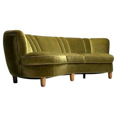 a green couch sitting on top of a wooden frame