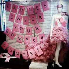 a mannequin is dressed in pink and has letters written on it to spell out the word ladies check your bumps