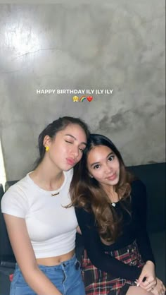 two young women sitting next to each other in front of a birthday card that says happy birthday lily