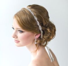 a woman wearing a headband with pearls on it